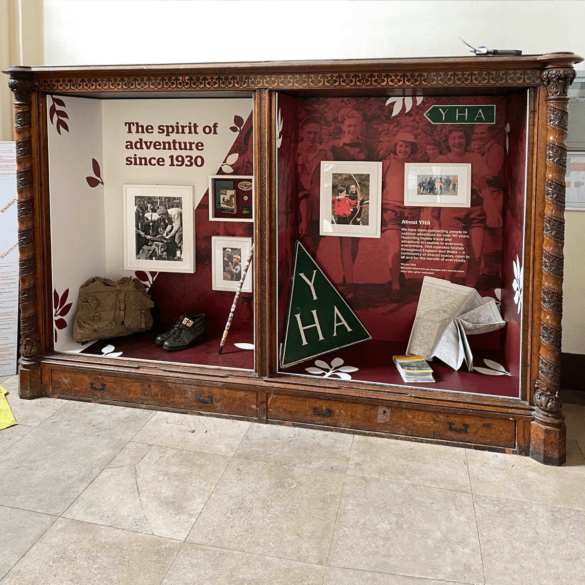 Photograph of threedimensional Spirit of adventure heritage interpretation installed into an antique bookcase at YHA Ilam Hall
